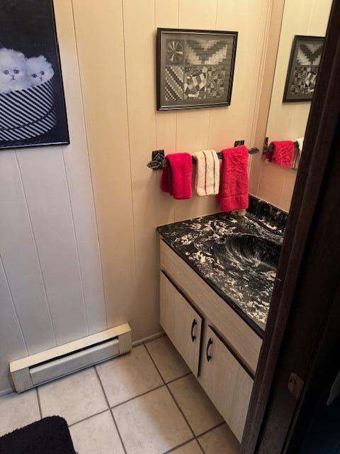 W6782 Marine Dr, Markesan, WI 53946 - bathroom featuring vanity, baseboard heating, tile patterned floors, and a decorative wall