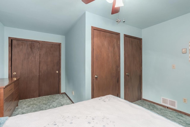 W6782 Marine Dr, Markesan, WI 53946 - carpeted bedroom with two closets, baseboards, and a ceiling fan