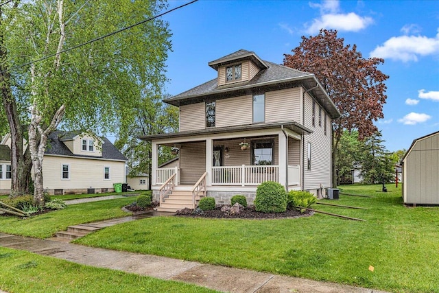 611 Highland Ave, Kewaskum, WI 53040 - traditional style home with a porch, a front lawn, and cooling unit