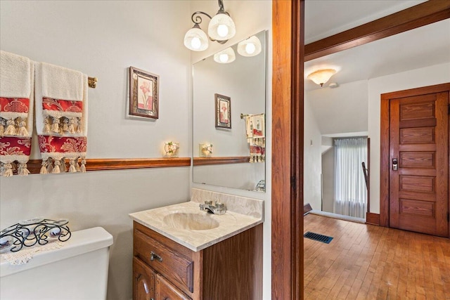 611 Highland Ave, Kewaskum, WI 53040 - bathroom with vanity, toilet, hardwood / wood-style flooring, and baseboards