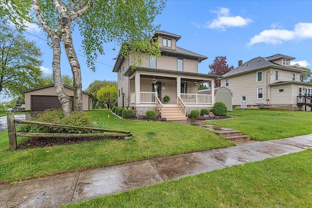 611 Highland Ave, Kewaskum, WI 53040 - american foursquare style home with a porch, an outdoor structure, a front yard, and a detached garage