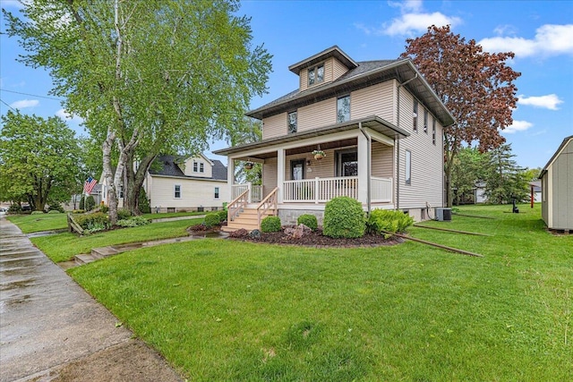 611 Highland Ave, Kewaskum, WI 53040 - american foursquare style home featuring covered porch, a front lawn, and central air condition unit