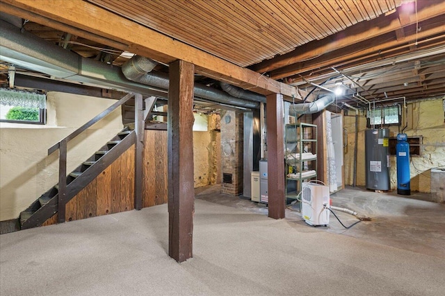 611 Highland Ave, Kewaskum, WI 53040 - below grade area with water heater, plenty of natural light, stairway, and a water softener system