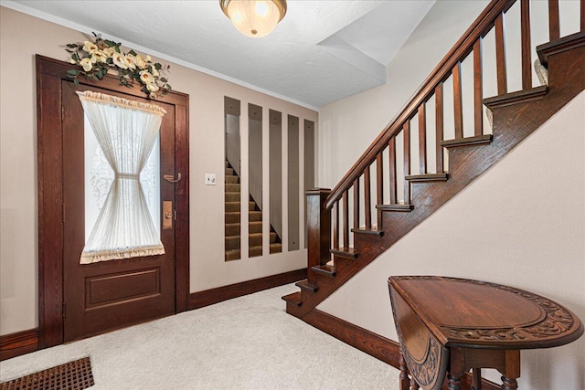 611 Highland Ave, Kewaskum, WI 53040 - entryway with carpet floors, stairs, and baseboards