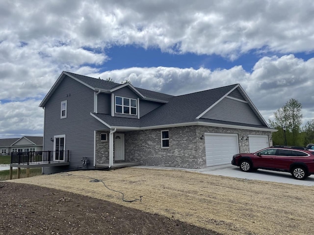 412 Emerald Ct, Kewaskum, WI 53040 - view of front of house featuring an attached garage, a wooden deck, brick siding, roof with shingles, and driveway