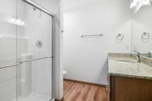 412 Emerald Ct, Kewaskum, WI 53040 - full bath with vanity, a shower with shower door, toilet, and wood finished floors