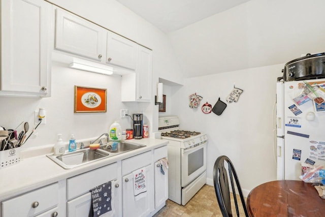 2202 N 55th St, Milwaukee, WI 53208 - kitchen with white appliances, a sink, white cabinets, light countertops, and vaulted ceiling