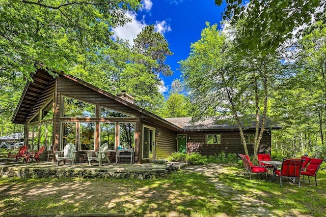 12711 Wind Point Rd, Manitowish Waters, WI 54545 - rear view of house featuring a patio area and a chimney