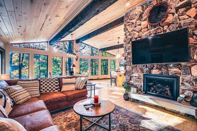 12711 Wind Point Rd, Manitowish Waters, WI 54545 - living area with wood finished floors, a stone fireplace, and wooden ceiling