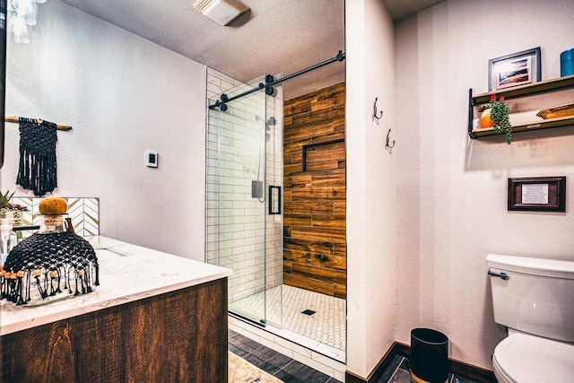 12711 Wind Point Rd, Manitowish Waters, WI 54545 - full bathroom with toilet, a stall shower, a textured wall, a textured ceiling, and vanity