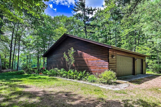 12711 Wind Point Rd, Manitowish Waters, WI 54545 - view of home's exterior with a detached garage and a lawn