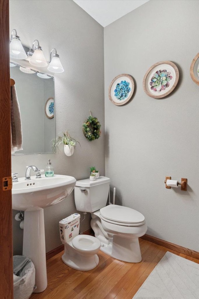 405 August Hills Dr, La Crescent, MN 55947 - half bathroom with wood finished floors, toilet, and baseboards
