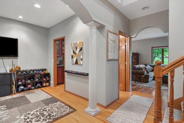 405 August Hills Dr, La Crescent, MN 55947 - corridor with arched walkways, ornate columns, light wood-style floors, recessed lighting, and baseboards