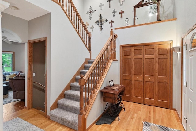 405 August Hills Dr, La Crescent, MN 55947 - entrance foyer featuring light wood-style flooring, a high ceiling, stairway, ceiling fan, and baseboards