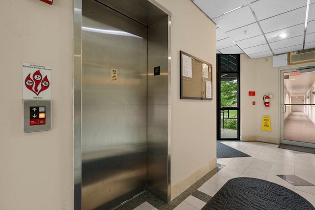 50 Hemlock St Unit 4, Sauk City, WI 53583 - hall featuring elevator, baseboards, and a drop ceiling