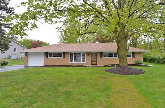 12100 44th Ave, Pleasant Prairie, WI 53158 - ranch-style house with brick siding, driveway, a garage, and a front yard