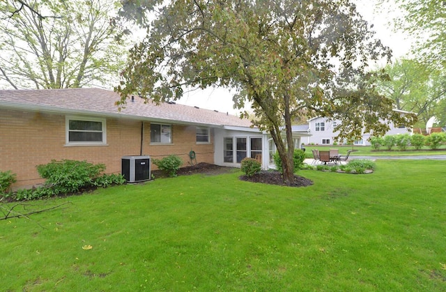 12100 44th Ave, Pleasant Prairie, WI 53158 - back of house with cooling unit, a yard, and brick siding