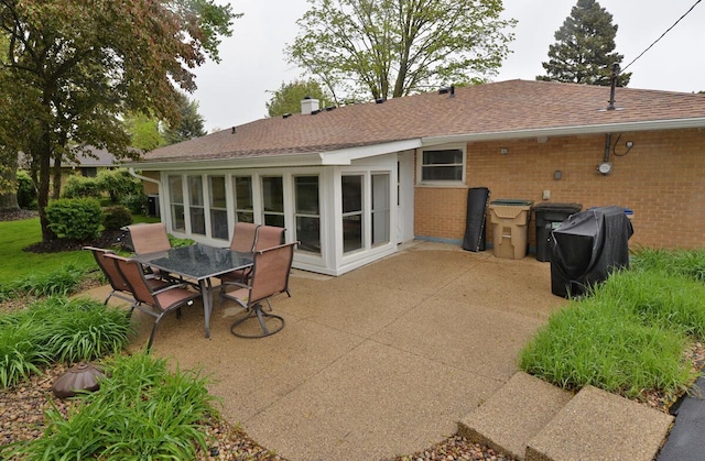 12100 44th Ave, Pleasant Prairie, WI 53158 - back of property featuring a patio area, brick siding, outdoor dining area, and roof with shingles