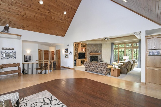 W360S9910 Markham Rd, Eagle, WI 53119 - living room with high vaulted ceiling, ceiling fan, wood finished floors, a large fireplace, and wood ceiling