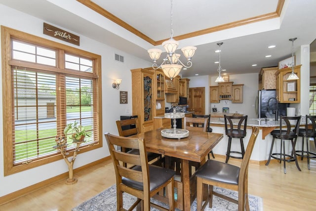 W360S9910 Markham Rd, Eagle, WI 53119 - dining room with a tray ceiling, light wood-style floors, ornamental molding, baseboards, and a chandelier