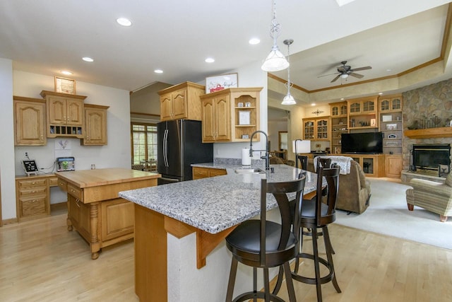 W360S9910 Markham Rd, Eagle, WI 53119 - kitchen featuring a sink, open shelves, freestanding refrigerator, light wood-type flooring, and a kitchen island