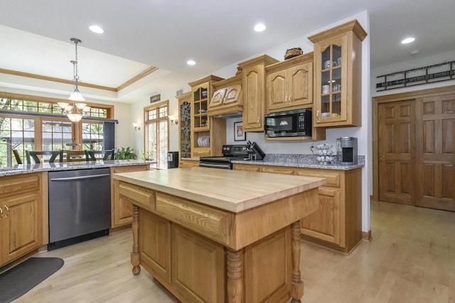 W360S9910 Markham Rd, Eagle, WI 53119 - kitchen featuring stainless steel dishwasher, range with electric stovetop, butcher block counters, light wood finished floors, and a kitchen island
