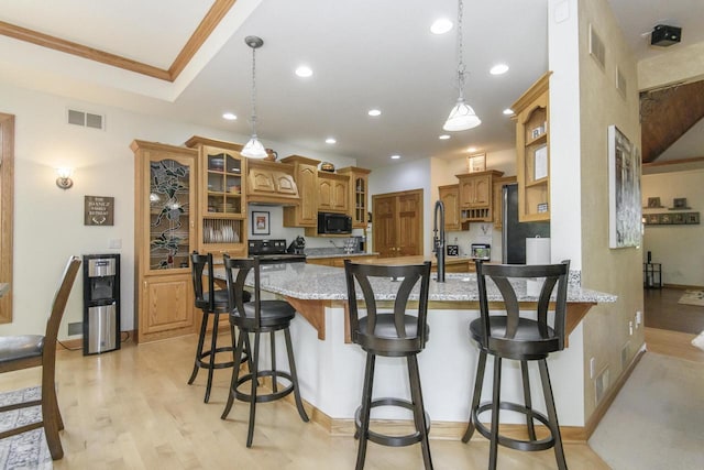 W360S9910 Markham Rd, Eagle, WI 53119 - kitchen with a peninsula, black appliances, glass insert cabinets, recessed lighting, and brown cabinetry