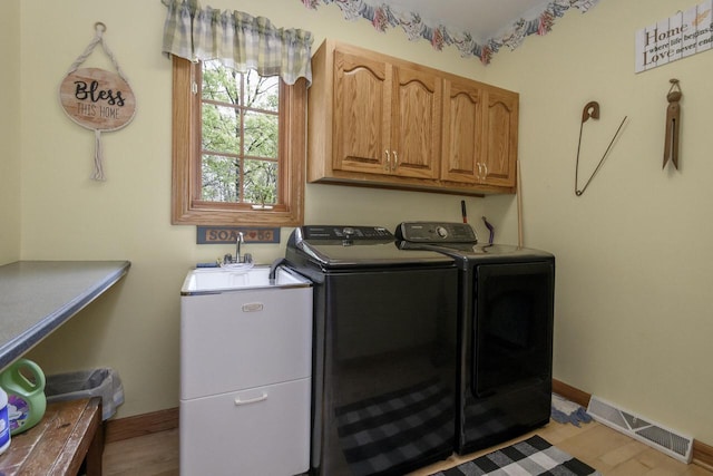W360S9910 Markham Rd, Eagle, WI 53119 - laundry room with cabinet space, washer and clothes dryer, light wood-style flooring, and baseboards