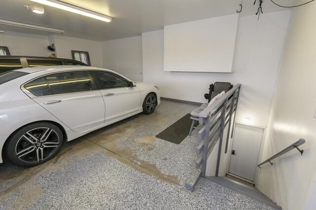 W360S9910 Markham Rd, Eagle, WI 53119 - garage featuring baseboards and a garage door opener