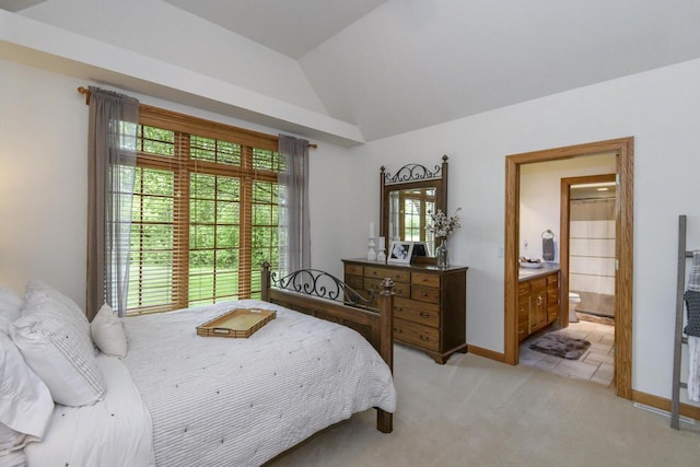 W360S9910 Markham Rd, Eagle, WI 53119 - bedroom with light colored carpet, vaulted ceiling, ensuite bath, and baseboards