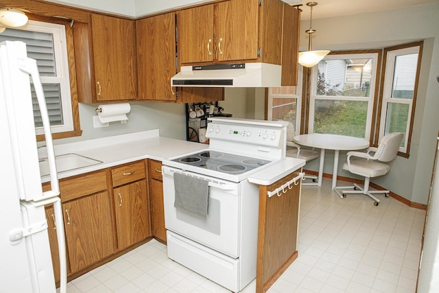 2373 S 83rd St, West Allis, WI 53219 - kitchen with white appliances, under cabinet range hood, brown cabinetry, light countertops, and decorative light fixtures