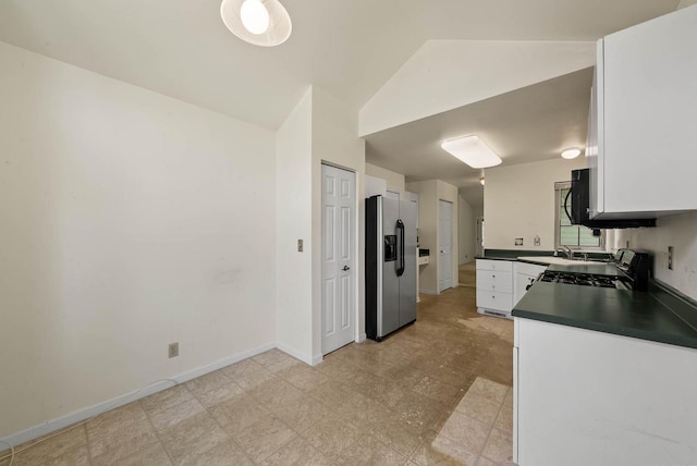 500 S Edwards Blvd Unit 1, Lake Geneva, WI 53147 - kitchen with stainless steel refrigerator with ice dispenser, dark countertops, white cabinetry, a sink, and black range oven