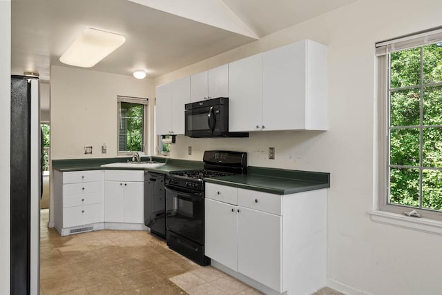 500 S Edwards Blvd Unit 1, Lake Geneva, WI 53147 - kitchen featuring black appliances, dark countertops, a sink, and plenty of natural light