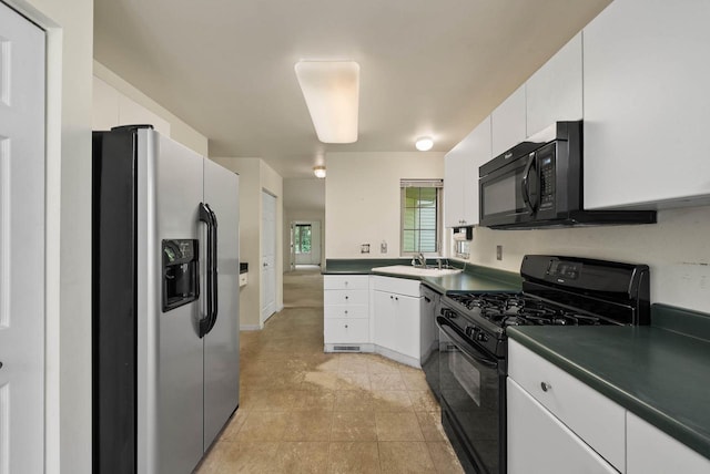 500 S Edwards Blvd Unit 1, Lake Geneva, WI 53147 - kitchen with black appliances, dark countertops, white cabinetry, a sink, and light tile patterned floors