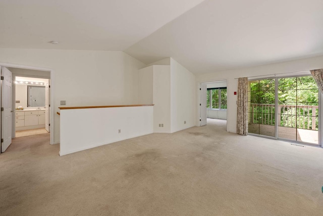 500 S Edwards Blvd Unit 1, Lake Geneva, WI 53147 - unfurnished room featuring light carpet and vaulted ceiling