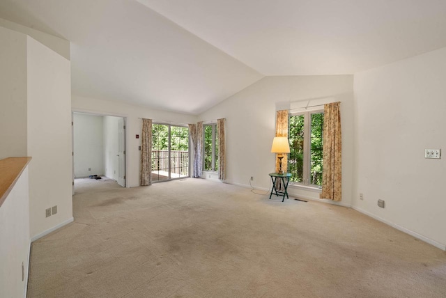 500 S Edwards Blvd Unit 1, Lake Geneva, WI 53147 - unfurnished room with healthy amount of natural light, lofted ceiling, light colored carpet, and baseboards