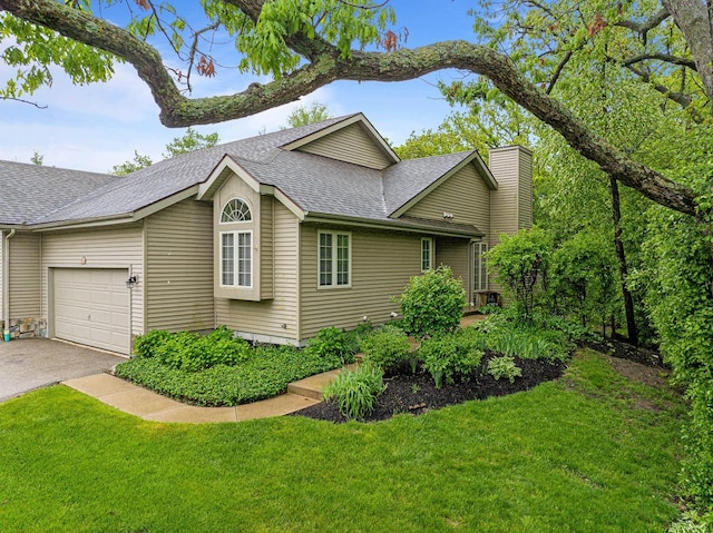 500 S Edwards Blvd Unit 1, Lake Geneva, WI 53147 - view of property exterior featuring an attached garage, a shingled roof, asphalt driveway, a lawn, and a chimney