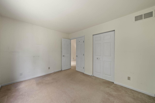 500 S Edwards Blvd Unit 1, Lake Geneva, WI 53147 - unfurnished bedroom featuring light colored carpet, baseboards, and a closet