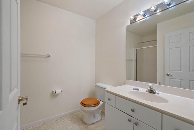 500 S Edwards Blvd Unit 1, Lake Geneva, WI 53147 - full bathroom with vanity, toilet, an enclosed shower, and baseboards