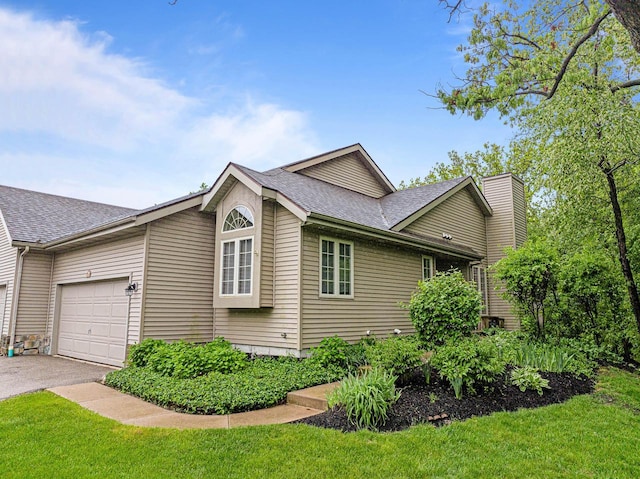 500 S Edwards Blvd Unit 1, Lake Geneva, WI 53147 - view of property exterior with roof with shingles, a garage, asphalt driveway, and a lawn
