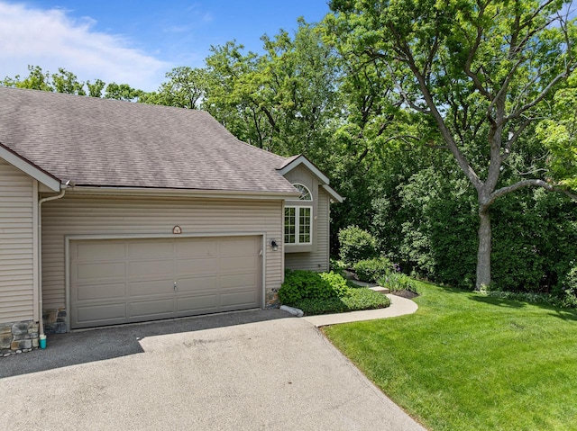 500 S Edwards Blvd Unit 1, Lake Geneva, WI 53147 - view of front of house featuring driveway, roof with shingles, a front yard, an attached garage, and stone siding