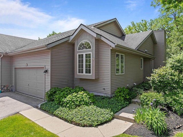 500 S Edwards Blvd Unit 1, Lake Geneva, WI 53147 - view of home's exterior with roof with shingles, a garage, and driveway
