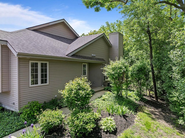 500 S Edwards Blvd Unit 1, Lake Geneva, WI 53147 - rear view of property featuring roof with shingles and a chimney