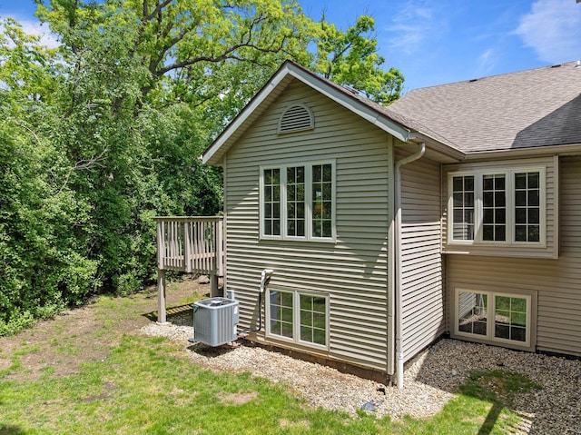 500 S Edwards Blvd Unit 1, Lake Geneva, WI 53147 - view of property exterior featuring central AC, a shingled roof, a lawn, and a deck