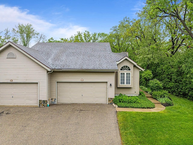 500 S Edwards Blvd Unit 1, Lake Geneva, WI 53147 - view of front of house featuring driveway, roof with shingles, an attached garage, and a front yard