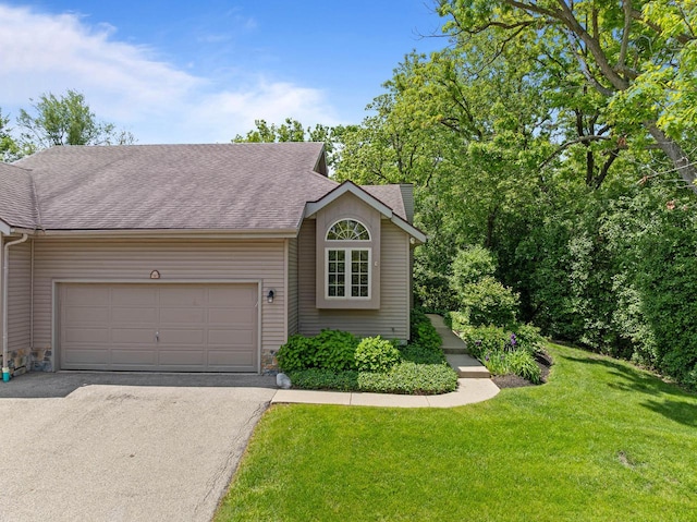 500 S Edwards Blvd Unit 1, Lake Geneva, WI 53147 - view of front facade featuring asphalt driveway, a garage, a front lawn, and roof with shingles