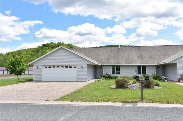 101 Baileyville Ct, Knapp, WI 54749 - ranch-style house featuring an attached garage, asphalt driveway, a front yard, and roof with shingles