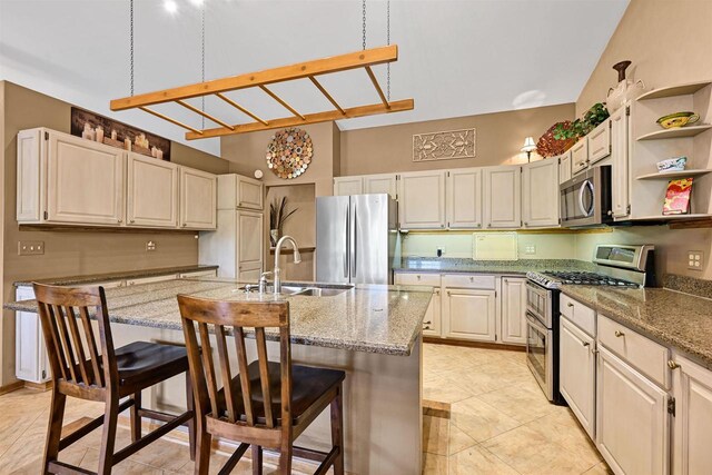 2511 S Natures Ridge Rd, Beloit, WI 53511 - kitchen featuring stainless steel appliances, a sink, open shelves, light stone counters, and a towering ceiling