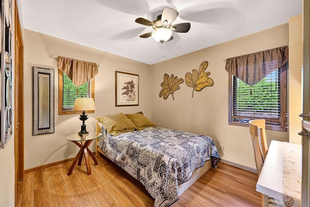 2511 S Natures Ridge Rd, Beloit, WI 53511 - bedroom with light wood-style floors, baseboards, and ceiling fan