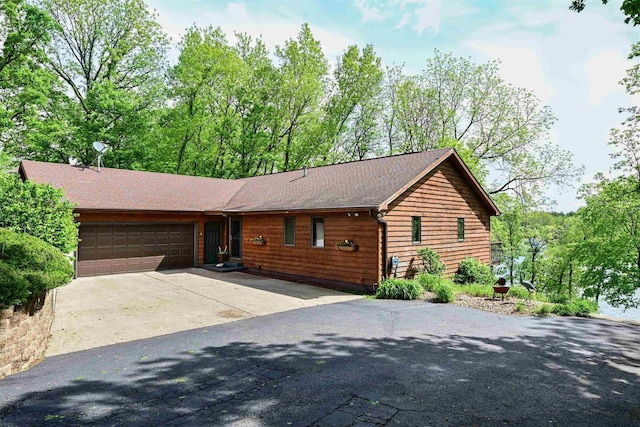 2511 S Natures Ridge Rd, Beloit, WI 53511 - rustic home featuring a garage, driveway, and roof with shingles
